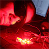 Student with protective eyewear next to experiment