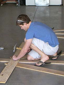 Student hammering nails into part of trebuchet